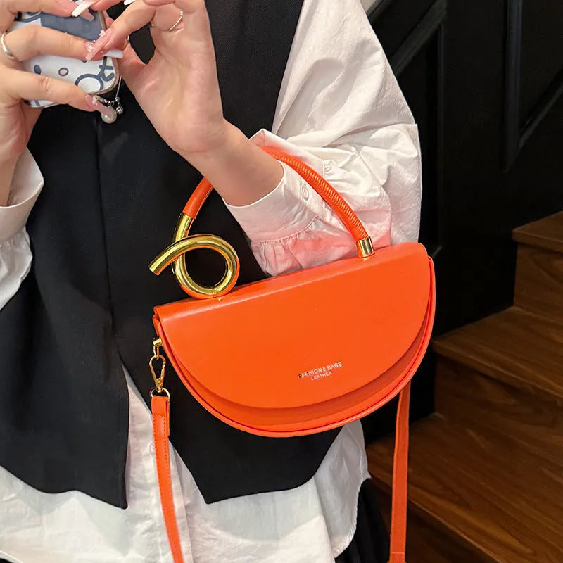 Medium hard PU box saddle bag in solid colour with internal zipper pocket and oval shape