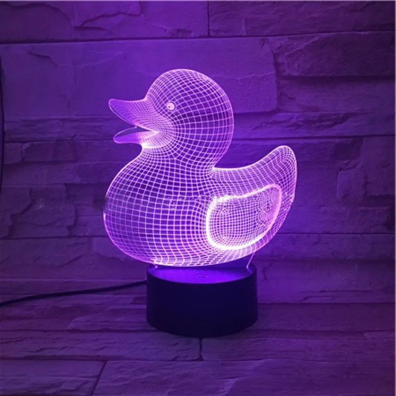 Little Yellow Duck shaped 3D acrylic night light with remote control on a table.
