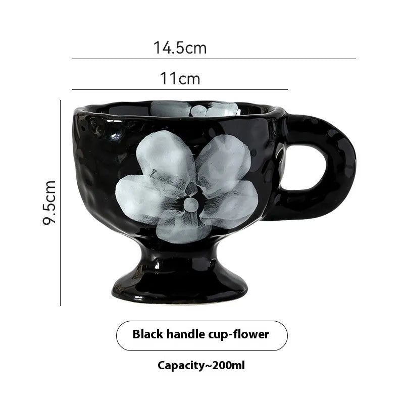 Irregularly shaped hand-pinched ceramic mug in a solid colour, shown on a plain background.