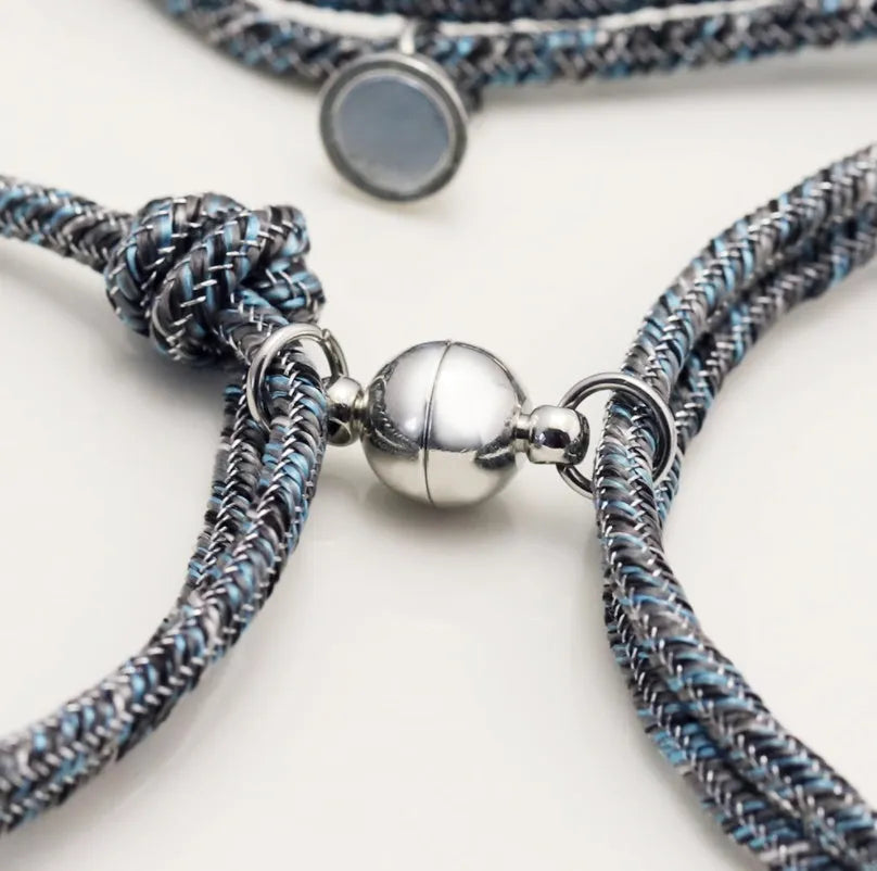Pair of stainless steel magnetic bracelets for couples, silver and rose gold finish, with adjustable hand rope
