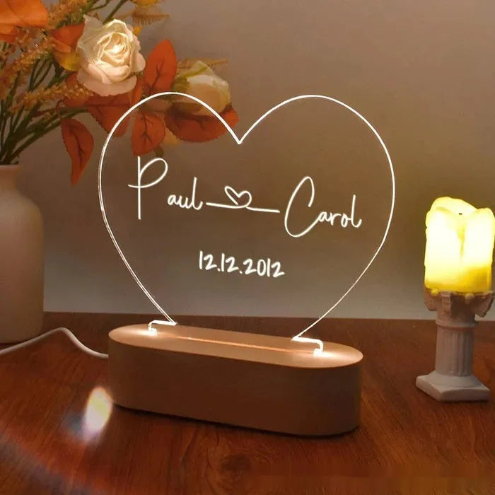 Custom transparent acrylic night light engraved with personal names and a date.