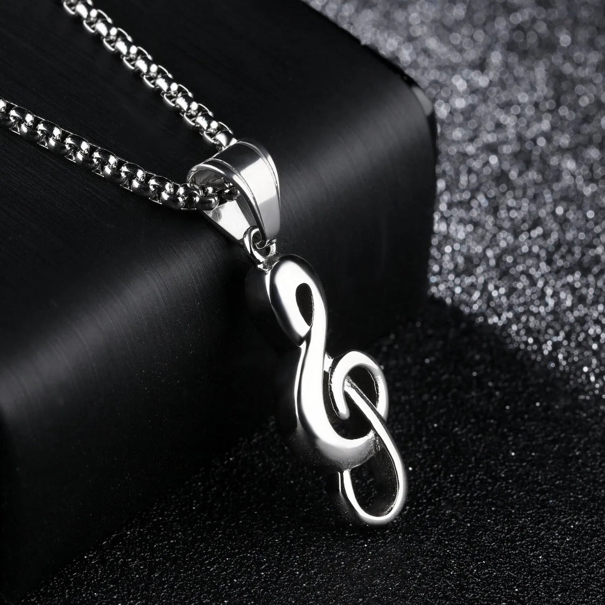 Titanium steel music symbol necklace in gold or silver colour, shown with and without chain