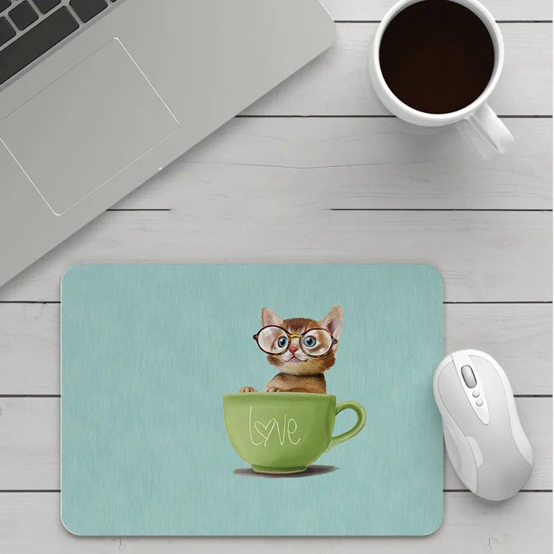 Thick custom cartoon mouse pad with colourful design on a desk, showing black seam edge