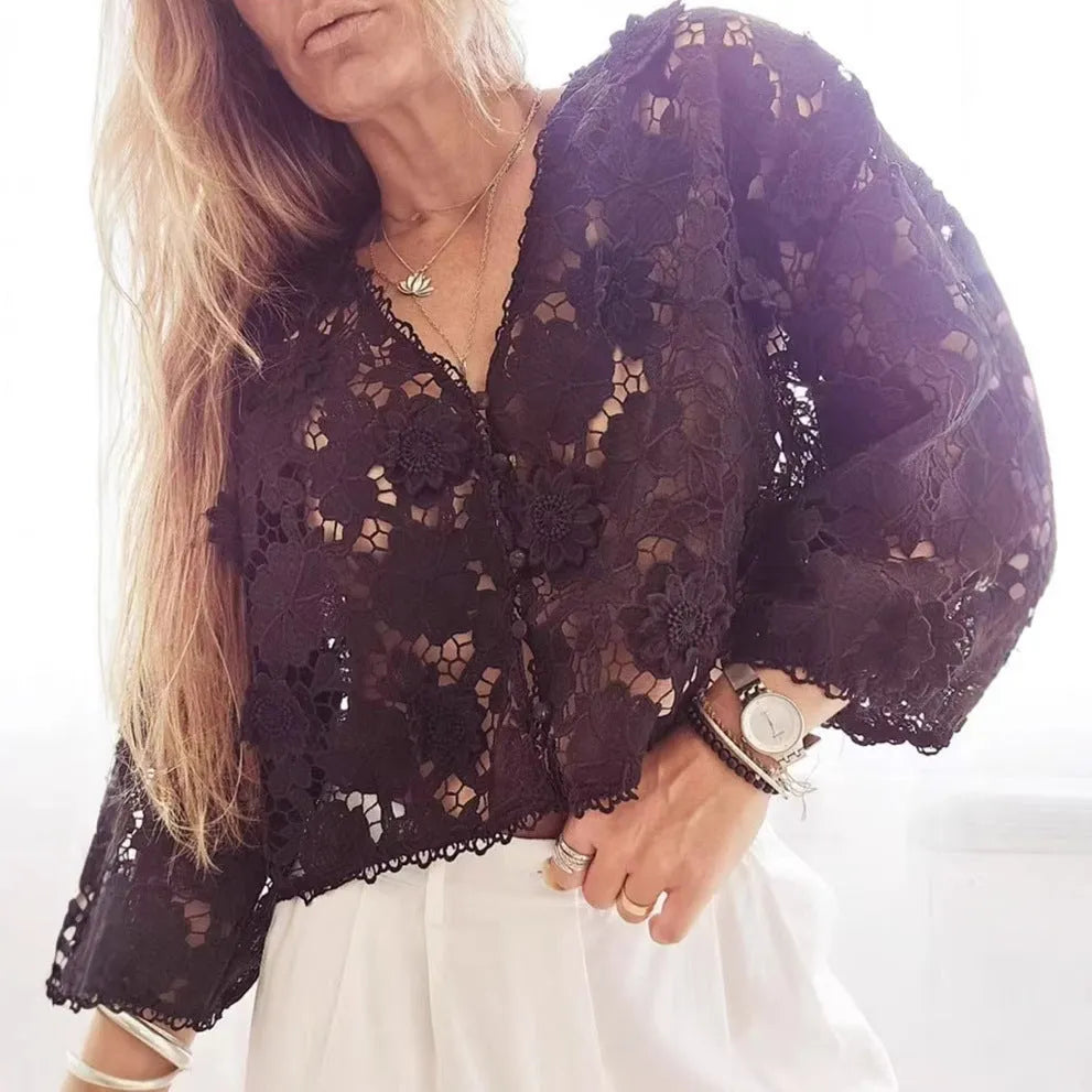 A women's loose black lace cardigan with a V-neck and three-dimensional floral decoration on the front.