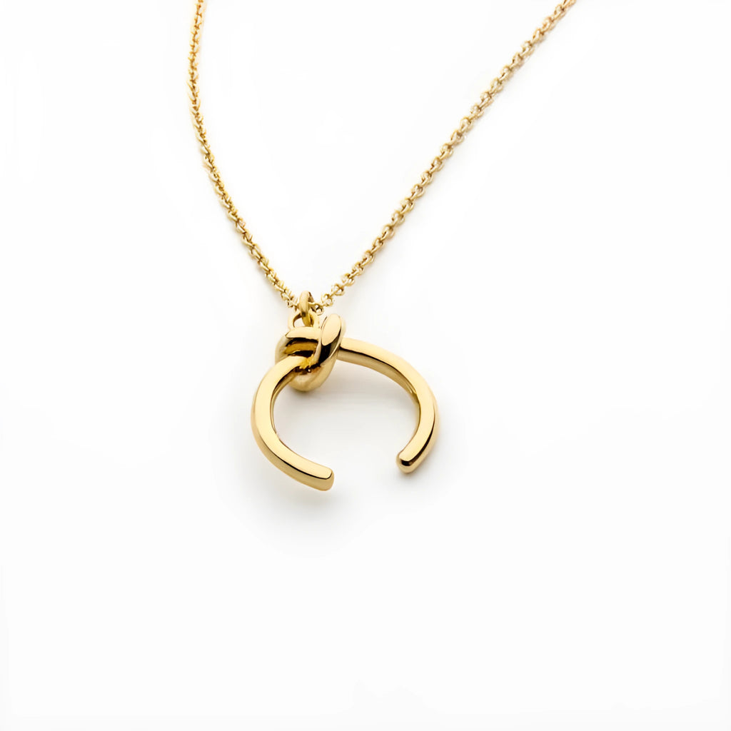 Vintage geometric copper pendant necklace with an adjustable cross chain in a gold finish.