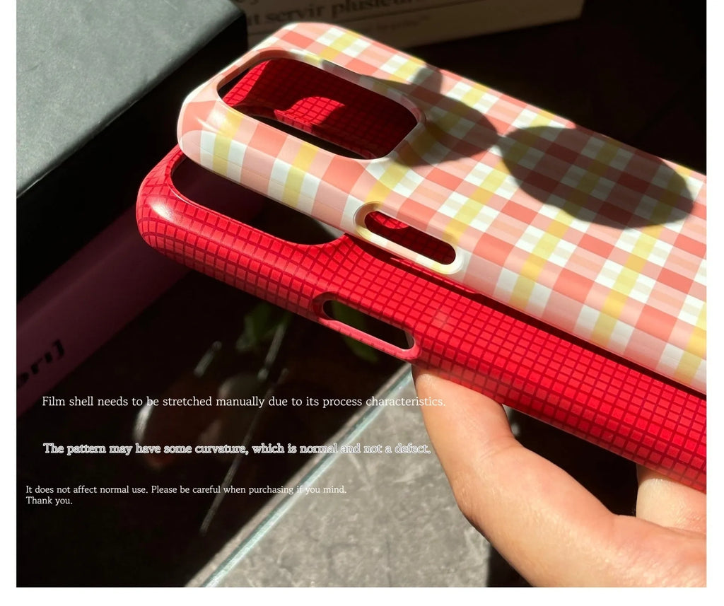 Red and orange plaid iPhone 15 Pro Max phone case with glossy and frosted finish options.