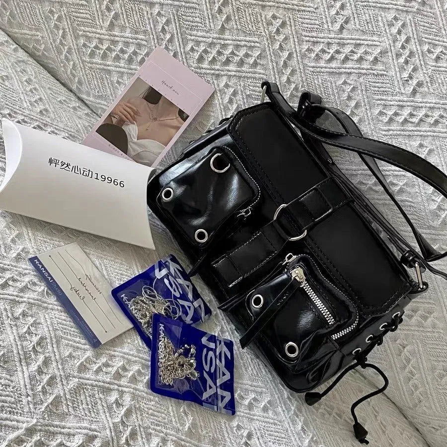 Black PU leather shoulder messenger bag showing adjustable strap and structured form