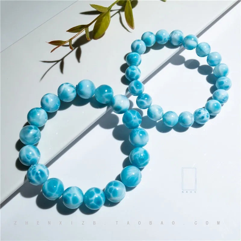 Blue bodhi bracelet with natural sea-pattern crystal stones and a single pearl bead.