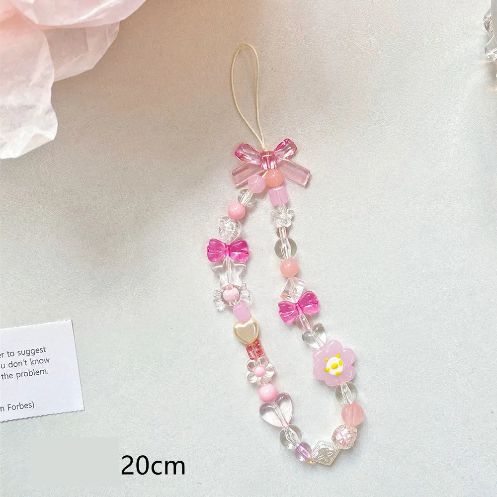 Yellow beaded flower mobile phone lanyard with plastic resin beads on a white background.