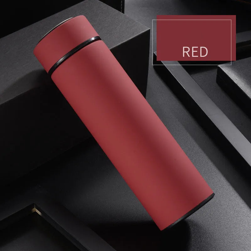 Stainless steel water bottle in black, blue, gold, or red with double wall vacuum insulation and arrow mouth.