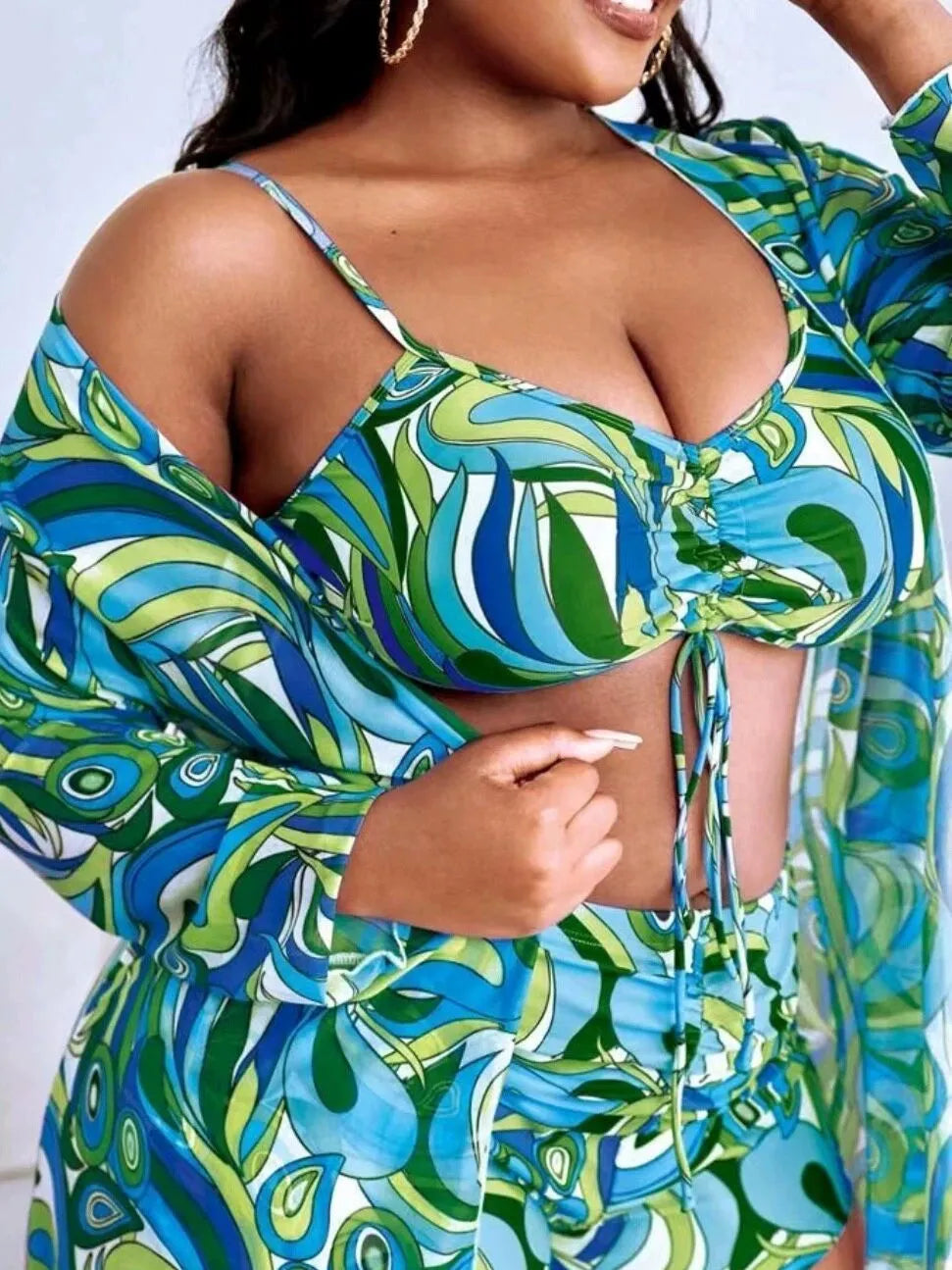 Women's floral print polyester bikini three-piece set with bra, shorts, and cardigan.
