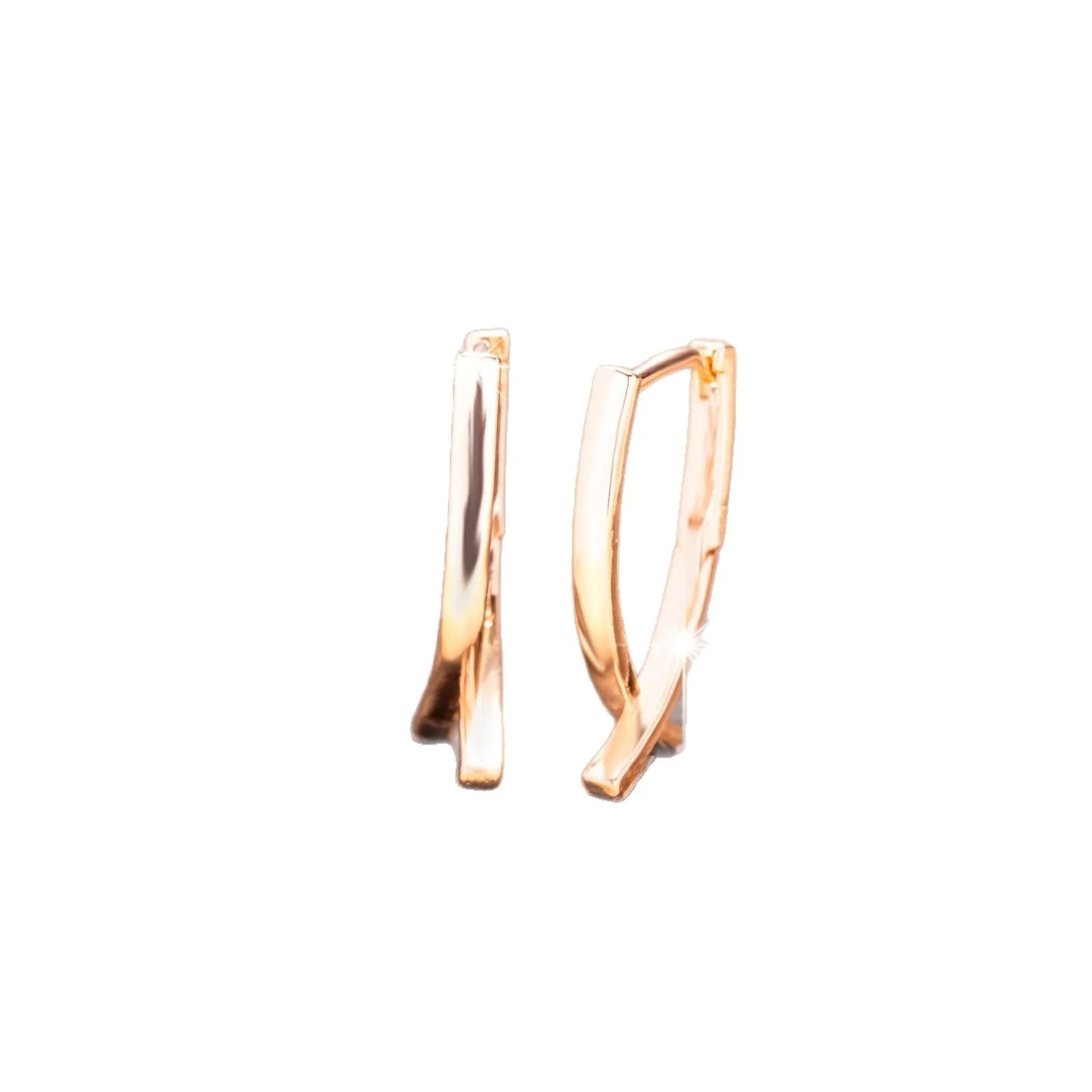 Close-up of a pair of rose gold cross drop earrings on a white background, showing post fittings.