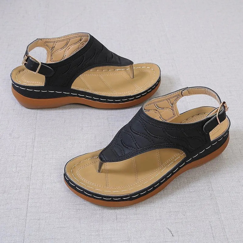 Women's black casual wedge heel sandals with an adjustable back strap buckle.