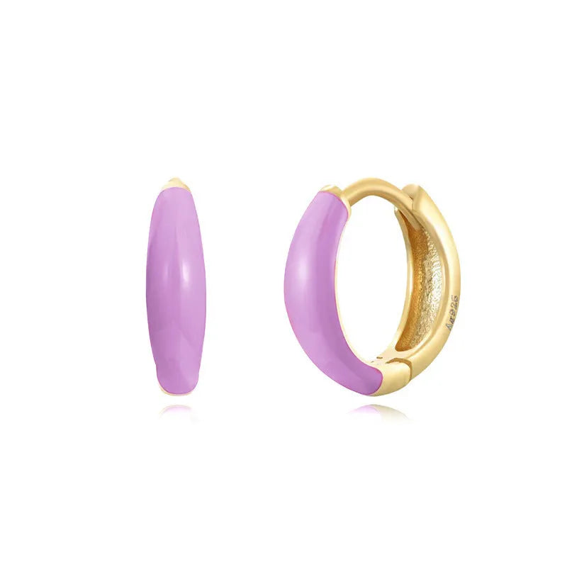 A pair of oval-shaped epoxy resin earrings on a U-shaped curved silver hook, showing a marbled colour finish.
