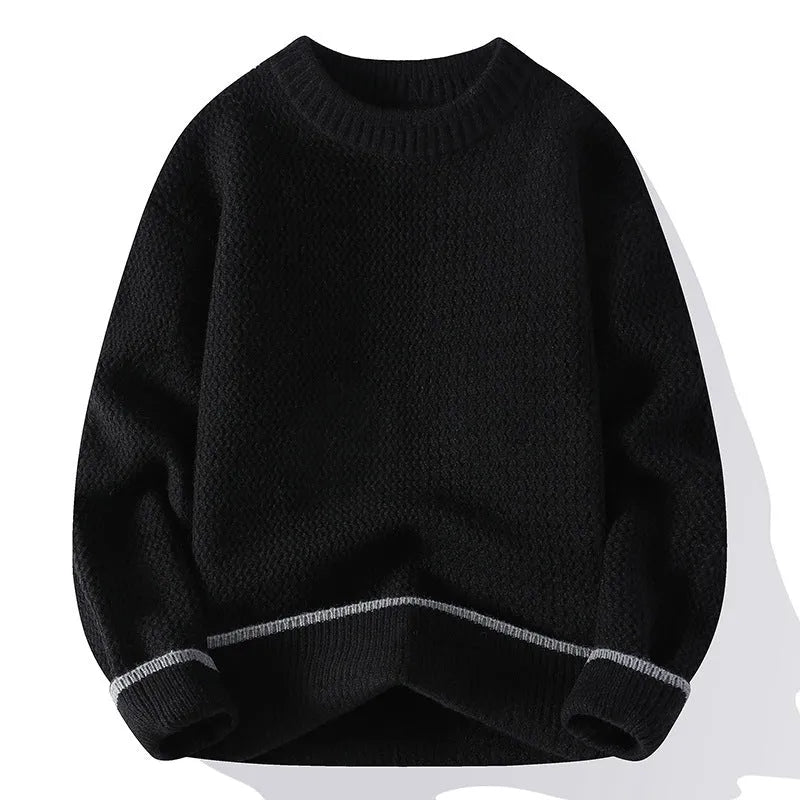 Man wearing a grey loose-fit round neck knitwear pullover sweater for casual autumn wear.