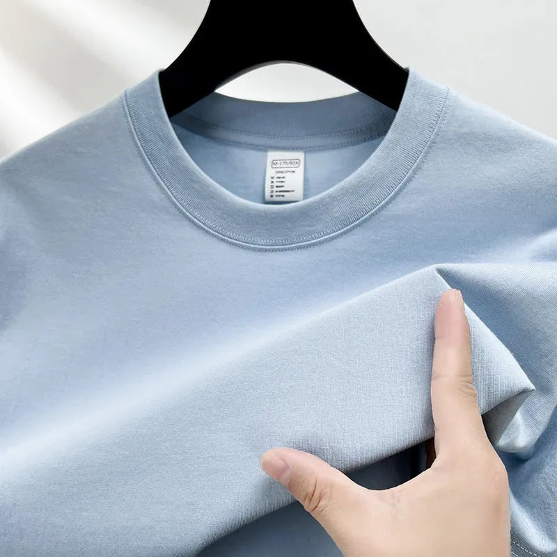 Men's solid colour cotton t-shirt with drop shoulder design on a hanger.