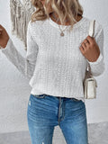White loose fit long sleeve round neck t-shirt on a hanger.
