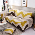 Printed geometric pattern stretch sofa slipcover fitted on a modern three-seater sofa.