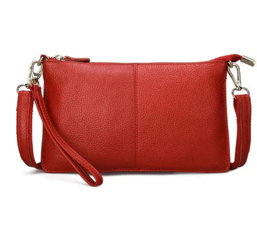 A cowhide lady slant bag in a chosen colour, showing hand and shoulder straps, with dimensions of 24 cm by 14 cm.