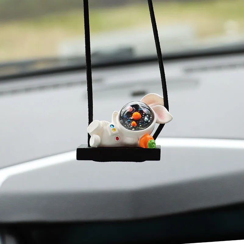 Cartoon style resin astronaut car pendant in five different colour and design variants.