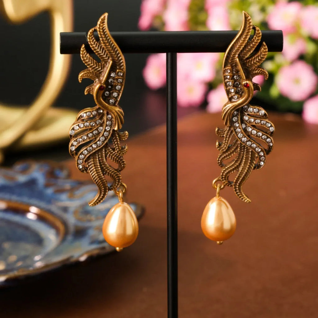 Pair of phoenix drop earrings in gold-tone electroplated alloy, hollow jeweled distressed design, 7cm by 1.6cm.