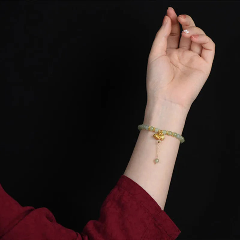 Two Shihuan natural Hetian jade bracelet with 6mm beads showing lotus and fu character designs