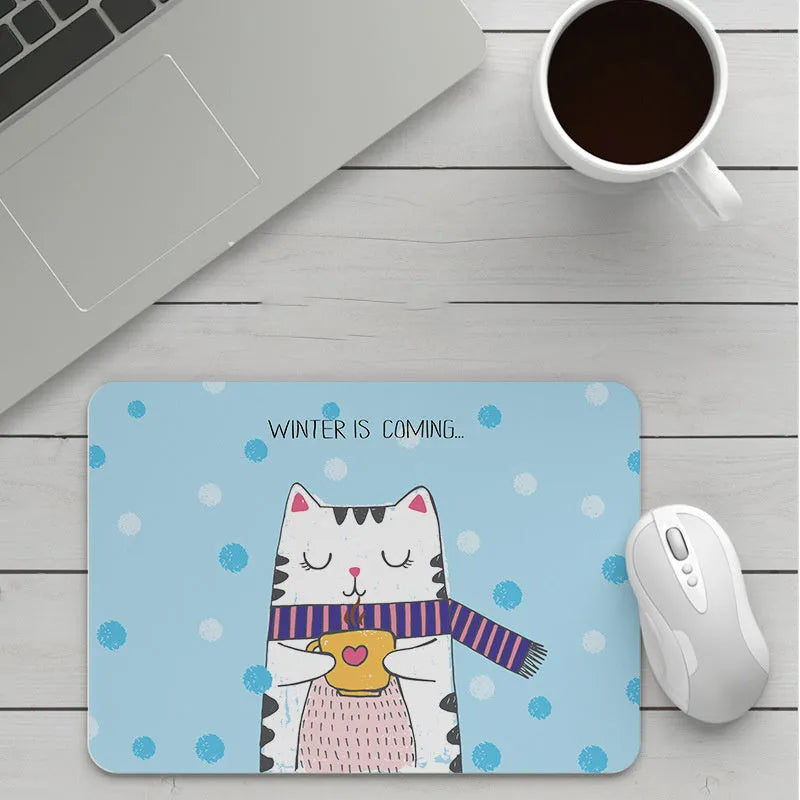 Thick custom cartoon mouse pad with colourful design on a desk, showing black seam edge