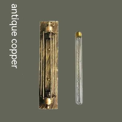Industrial retro flute shaped iron wall lamp in an antique finish, shown mounted on a wall.