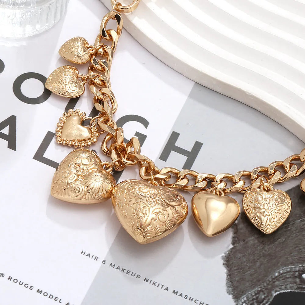 Exaggerated carved heart-shaped alloy pendant necklace on an adjustable metal chain.