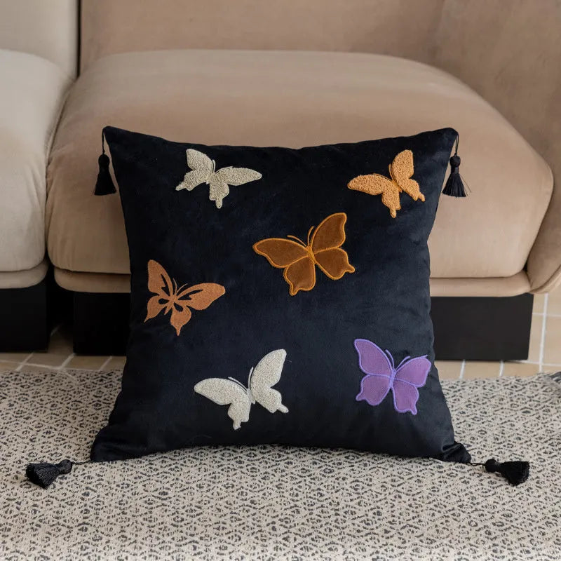 Square decorative cushion with Chinese-style butterfly embroidery in beige, black, and purple colours.