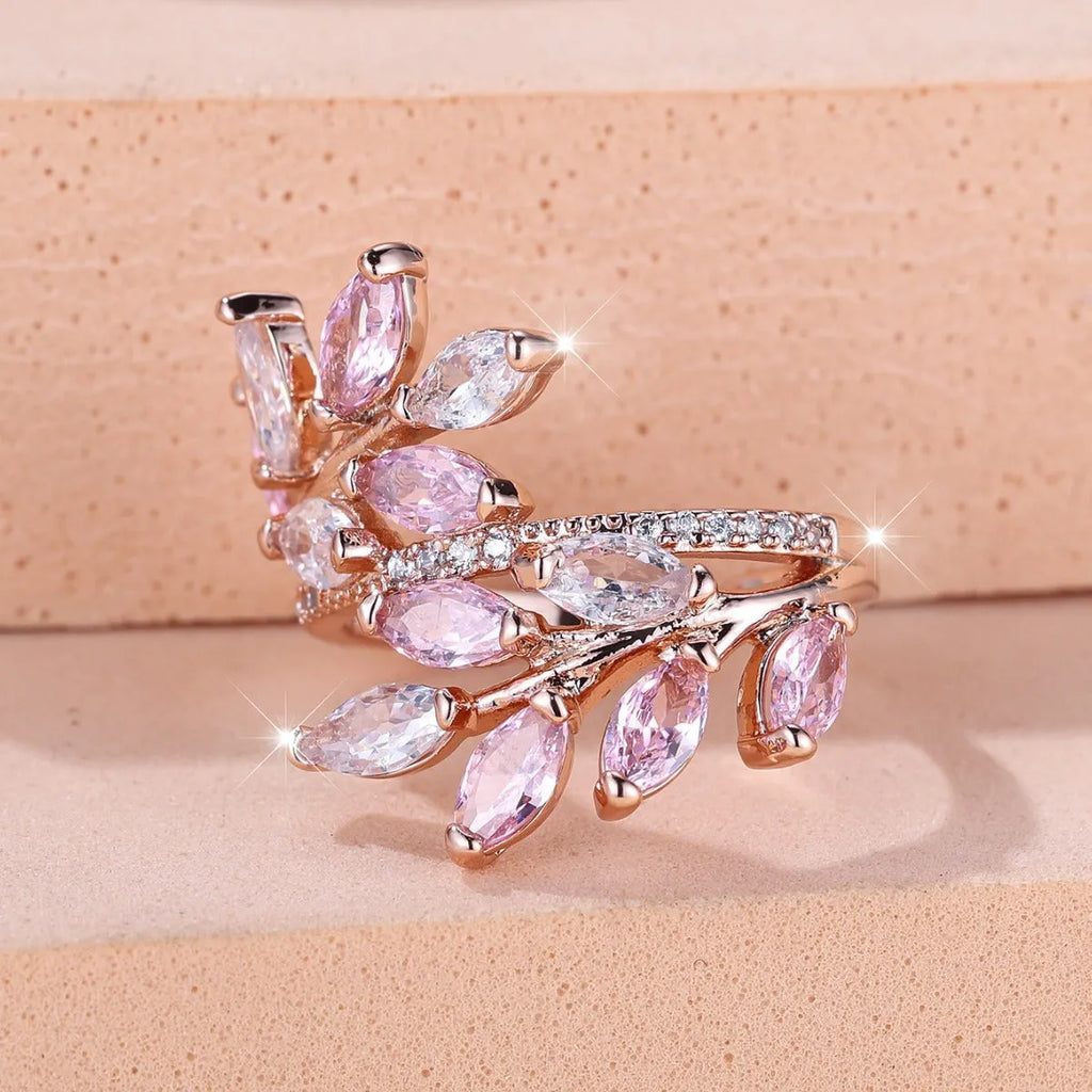 Adjustable copper leaf-shaped ring with a central horse eye zircon stone, shown in a rose gold finish.