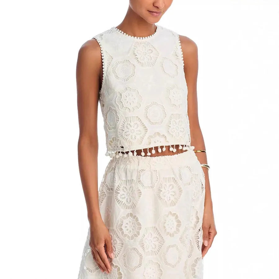 White women's sleeveless top and long skirt set with intricate embroidered retro art design detail.
