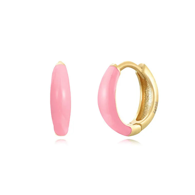 A pair of oval-shaped epoxy resin earrings on a U-shaped curved silver hook, showing a marbled colour finish.