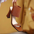 Women's black high heel sandals with a thin elastic ankle strap and a rubber sole.