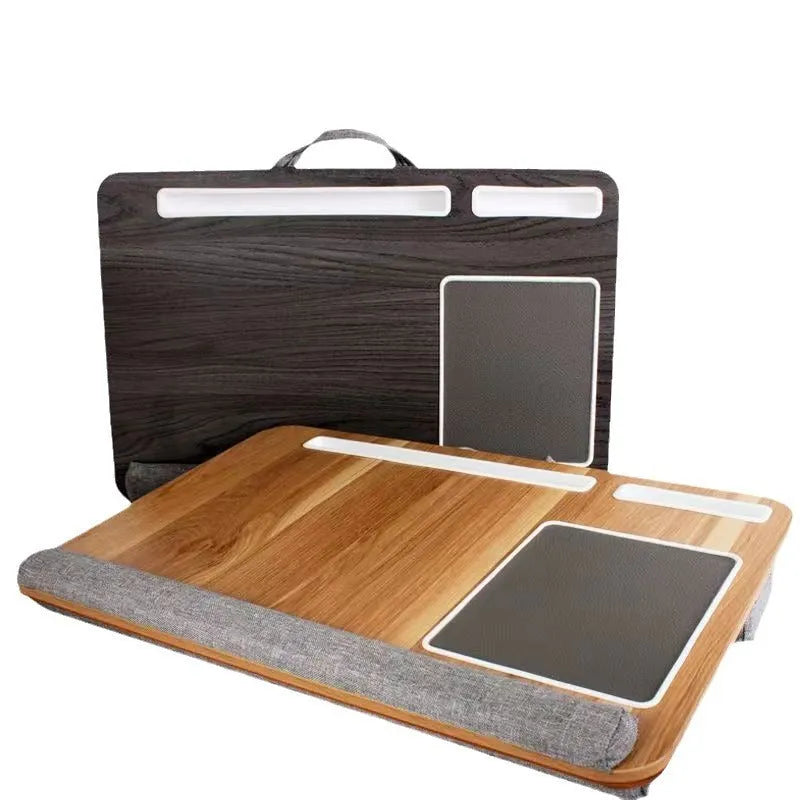 Foldable laptop desk in black walnut colour on a bed, showing open leg supports.