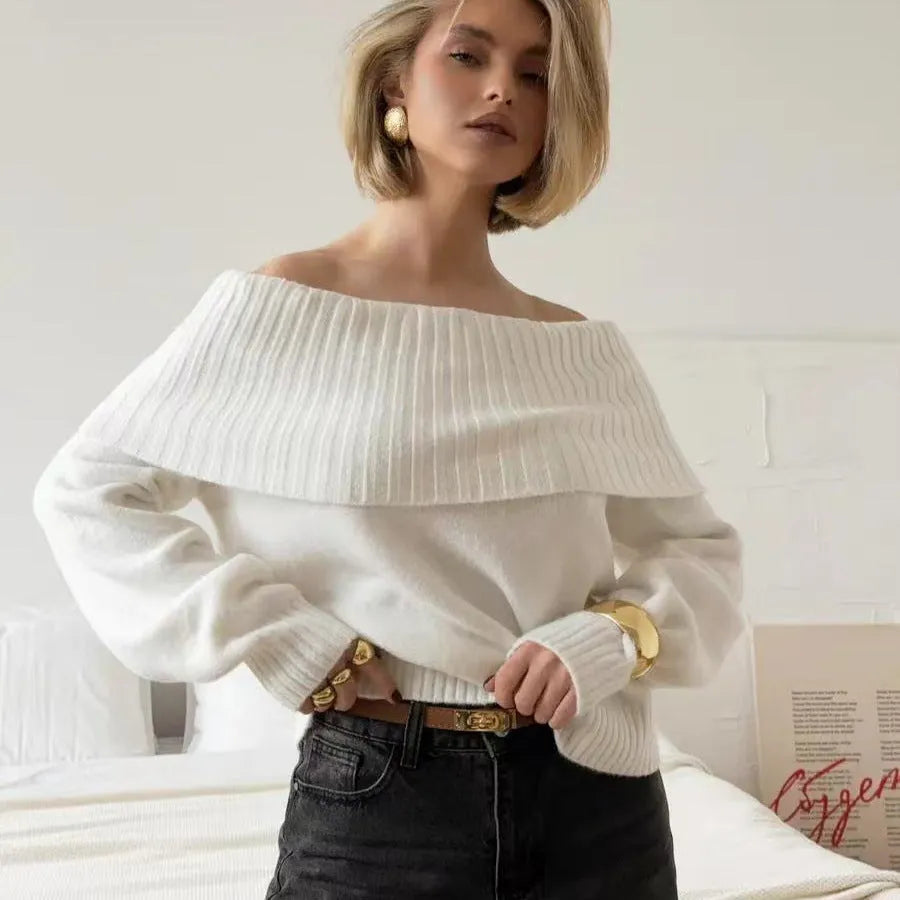 Grey off-the-shoulder sweater with a 3D pattern and strapless design on a model.