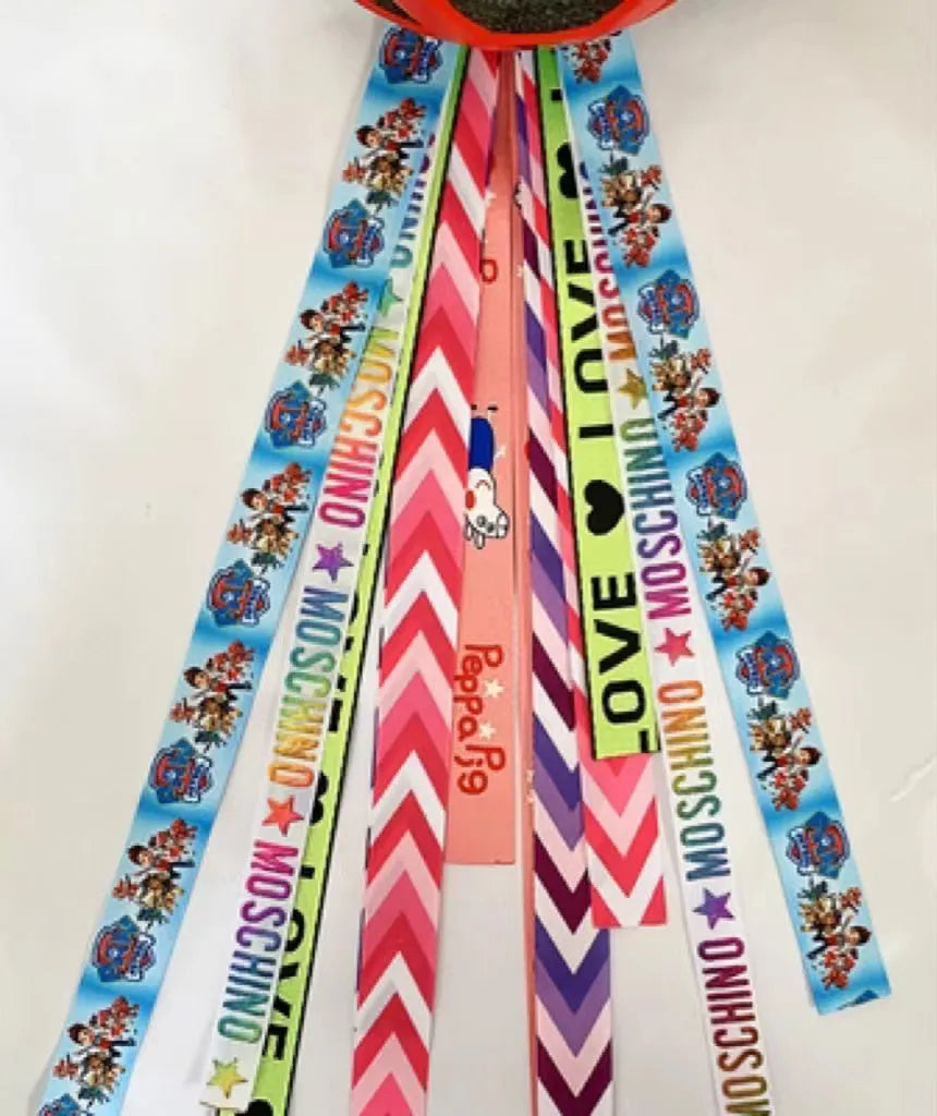 A decorative ribbon streamer for attaching to a child's roller skate or ski helmet, shown in a selection of colours.