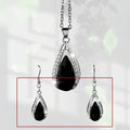 Black and red teardrop-shaped glass pendant necklace and matching earrings set on alloy chain.