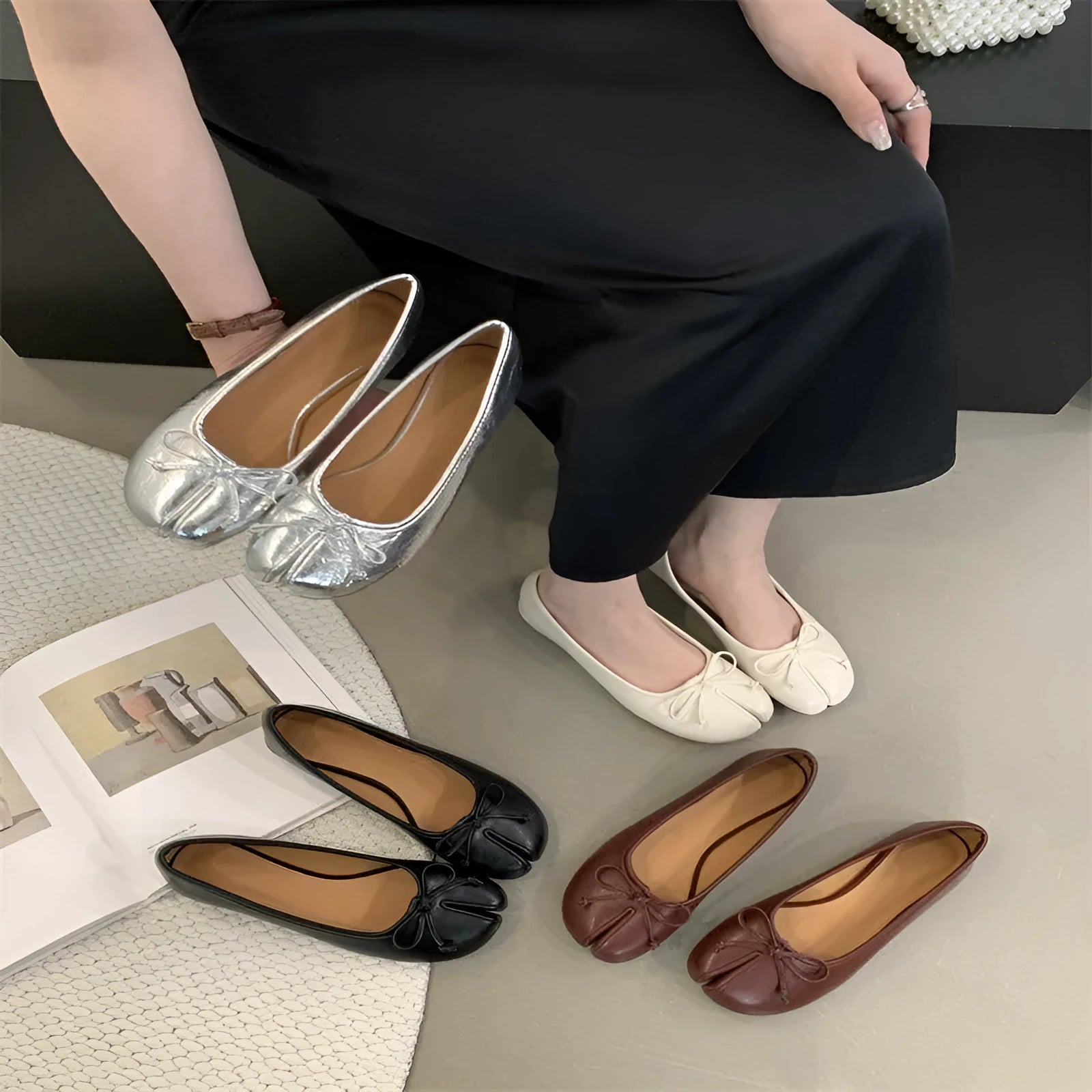 Women's split-toe flat pumps in beige with a round toe and flat rubber sole.