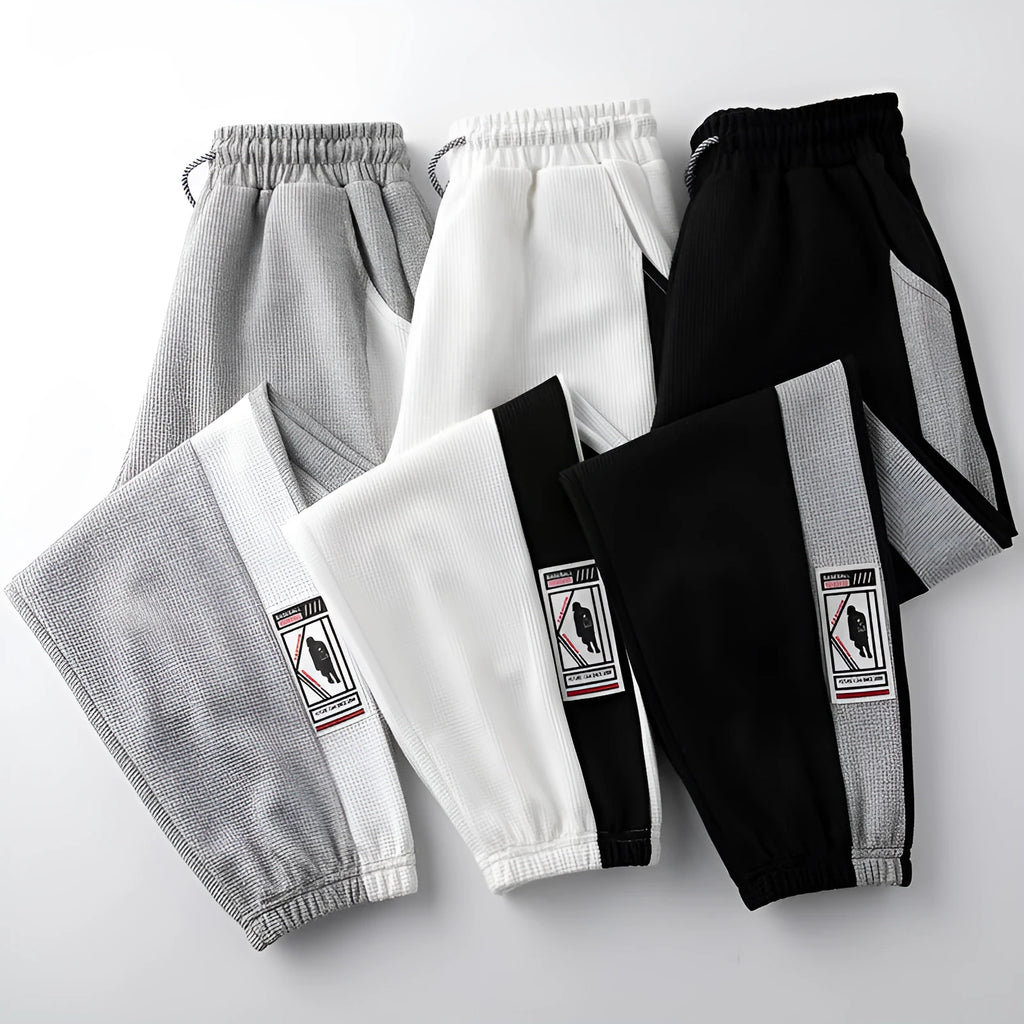 Men's casual wide leg fleece lined trousers in black, front view, showing drawstring waist and straight leg silhouette