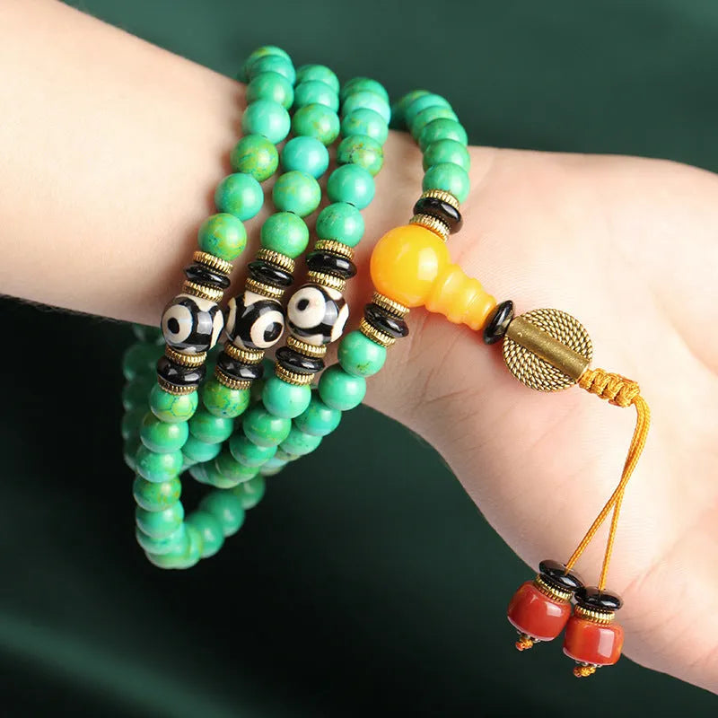Natural turquoise bracelet with 108 polished 8mm round beads on white background