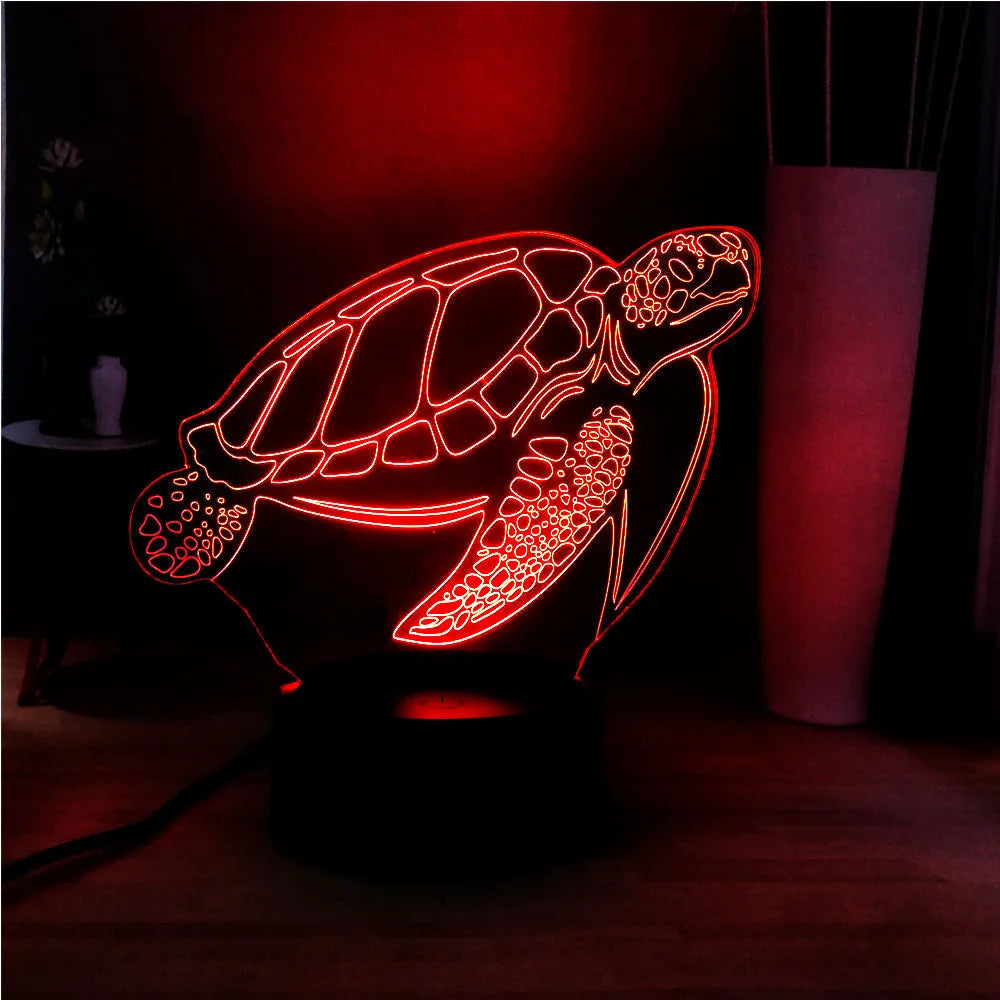 3D acrylic turtle-shaped LED night light with multi-colour illumination on a wooden surface.