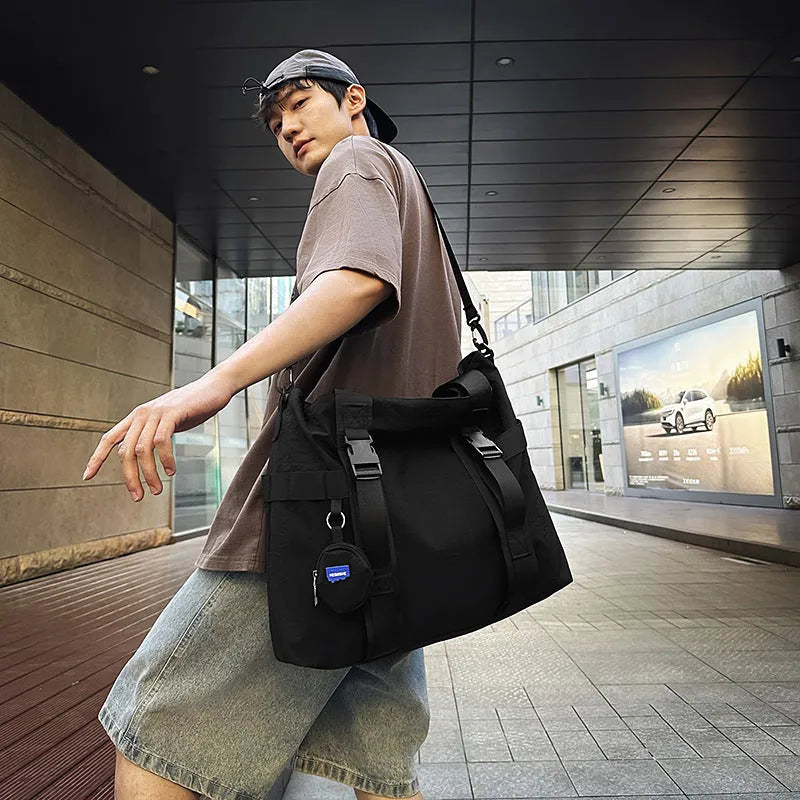 Men's grey Oxford cloth travel shoulder bag showing large main compartment and separate coin purse.