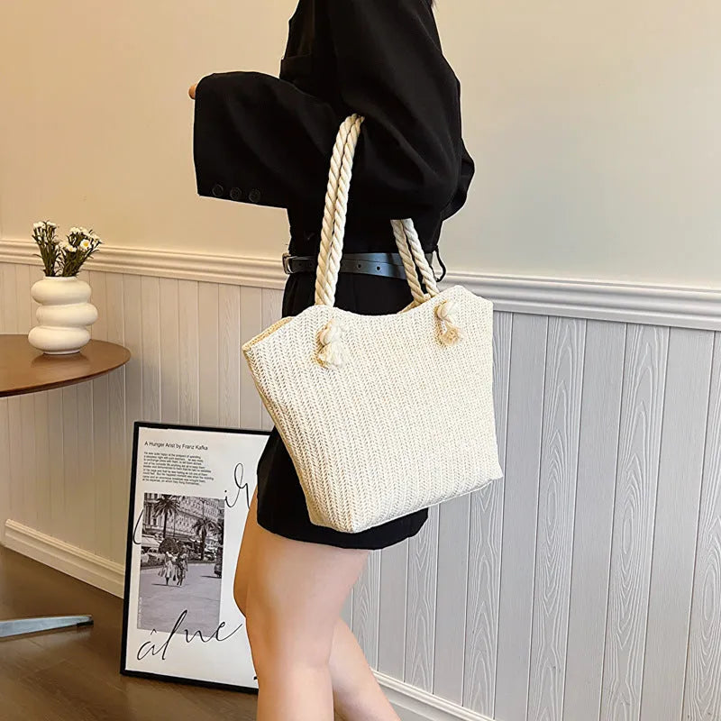Women's straw shoulder handbag in white or khaki with clamshell opening, single strap, and phone bag