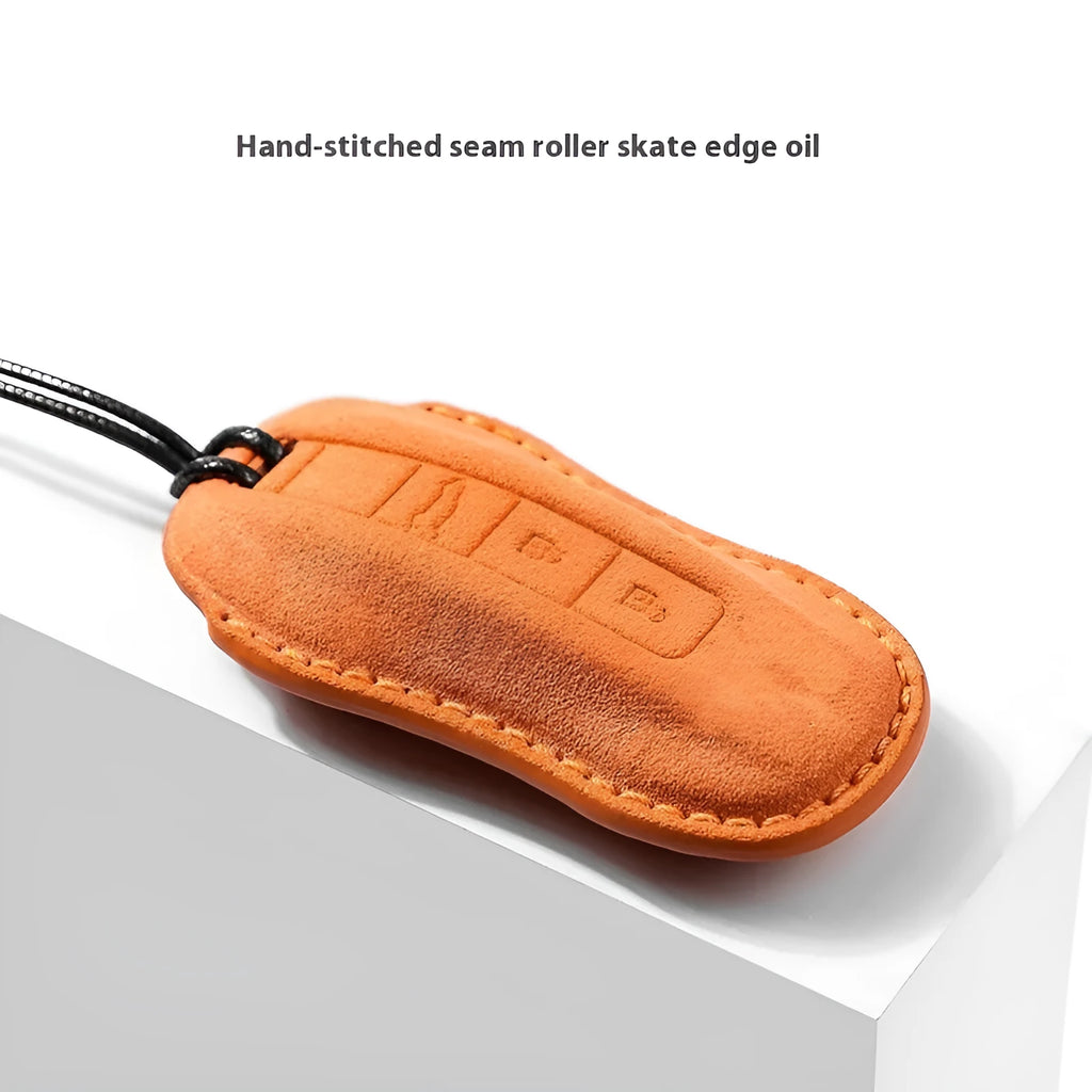 Suede car key cover in Cement Gray, Dark Green, Light Gray, and Orange colour options.