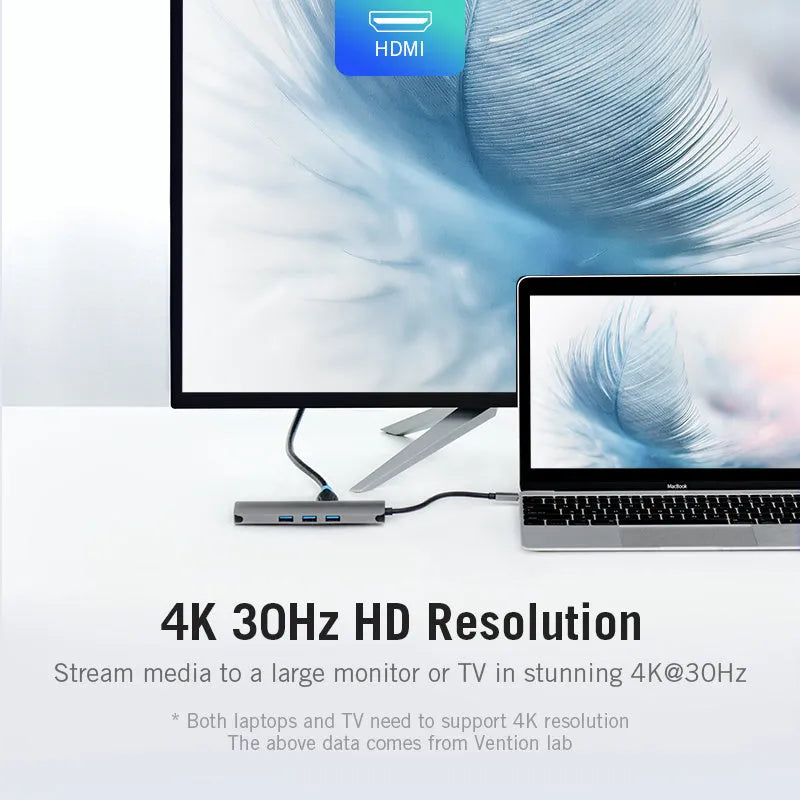 Deep grey USB-C to HDMI, Ethernet, and USB 3.0 multi-port adapter hub on a desk.