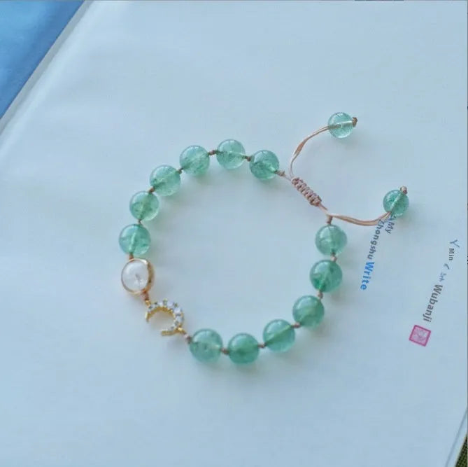 Handmade strawberry quartz crystal bracelet for women showing green strawberry quartz moon design.