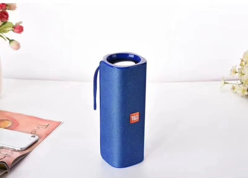 Cloth wireless Bluetooth speaker in multiple colours showing front grill and control buttons.
