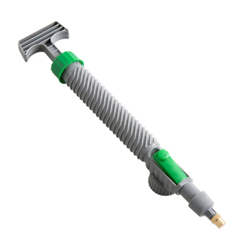 Plastic watering sprayer nozzle with extension tube attached to a large clear beverage bottle.