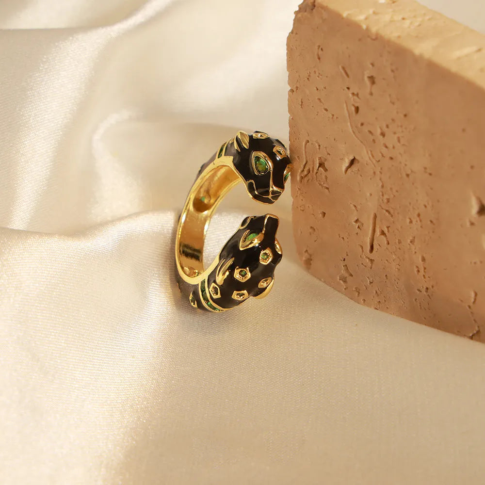 Geometric open ring with black cheetah oil drip print, size 7, on a copper band.